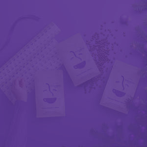 Gift Subscription featured mobile hero -- assorted Roaster's Blend coffee bags alongside scattered coffee beans, Christmas gift wrap, and a Christmas tree