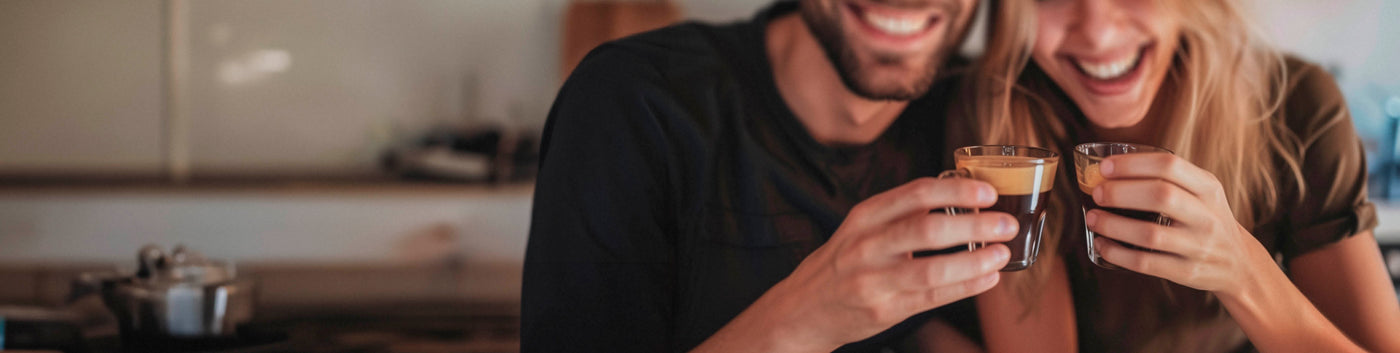 Espresso Subscription featured hero -- man and woman having a toast with small cups of espresso