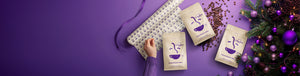 Gift Subscription featured hero -- assorted Roaster's Blend coffee bags alongside scattered coffee beans, Christmas gift wrap, and a Christmas tree