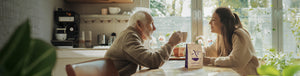 Grandparent's Day and Grandfather's Blend featured hero -- grandfather and granddaughter enjoying cups of our Grandfather's Blend at the kitchen table